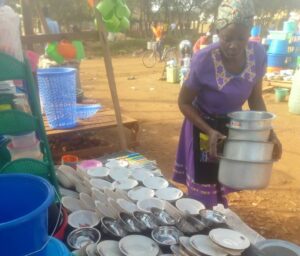 Mebra sets up her micro enterprise selling dishes and pots. 